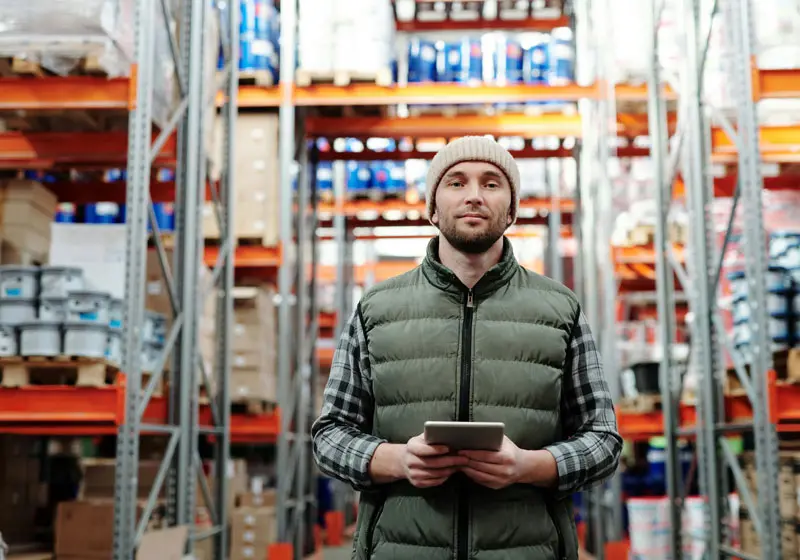 home image showing a man in a warehouse holding an ipad